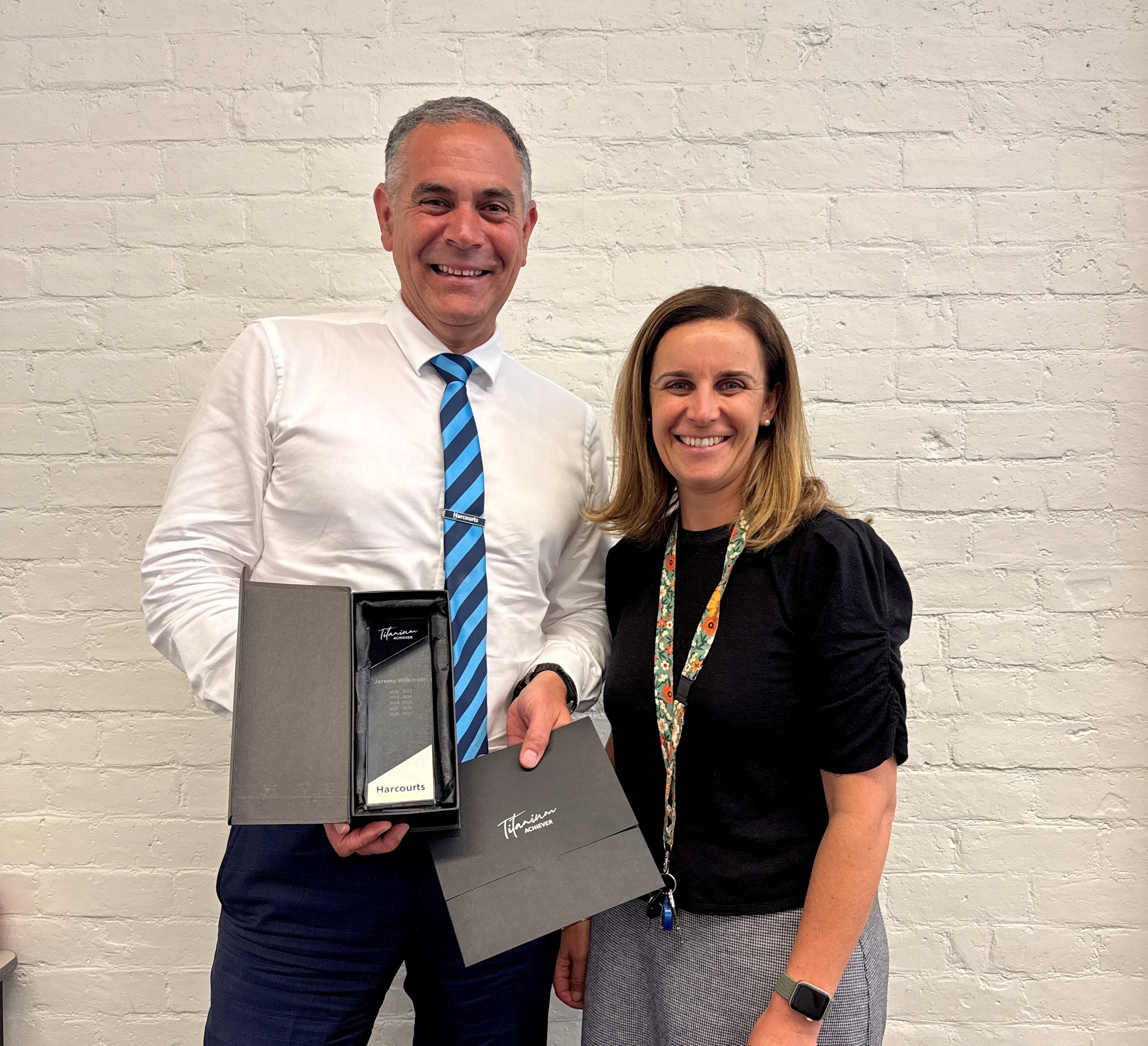 Harcourts Tasmania Co-CEO Kate Littlejohn congratulates Harcourts Launceston agent Jeremy Wilkinson on achieving Titanium status