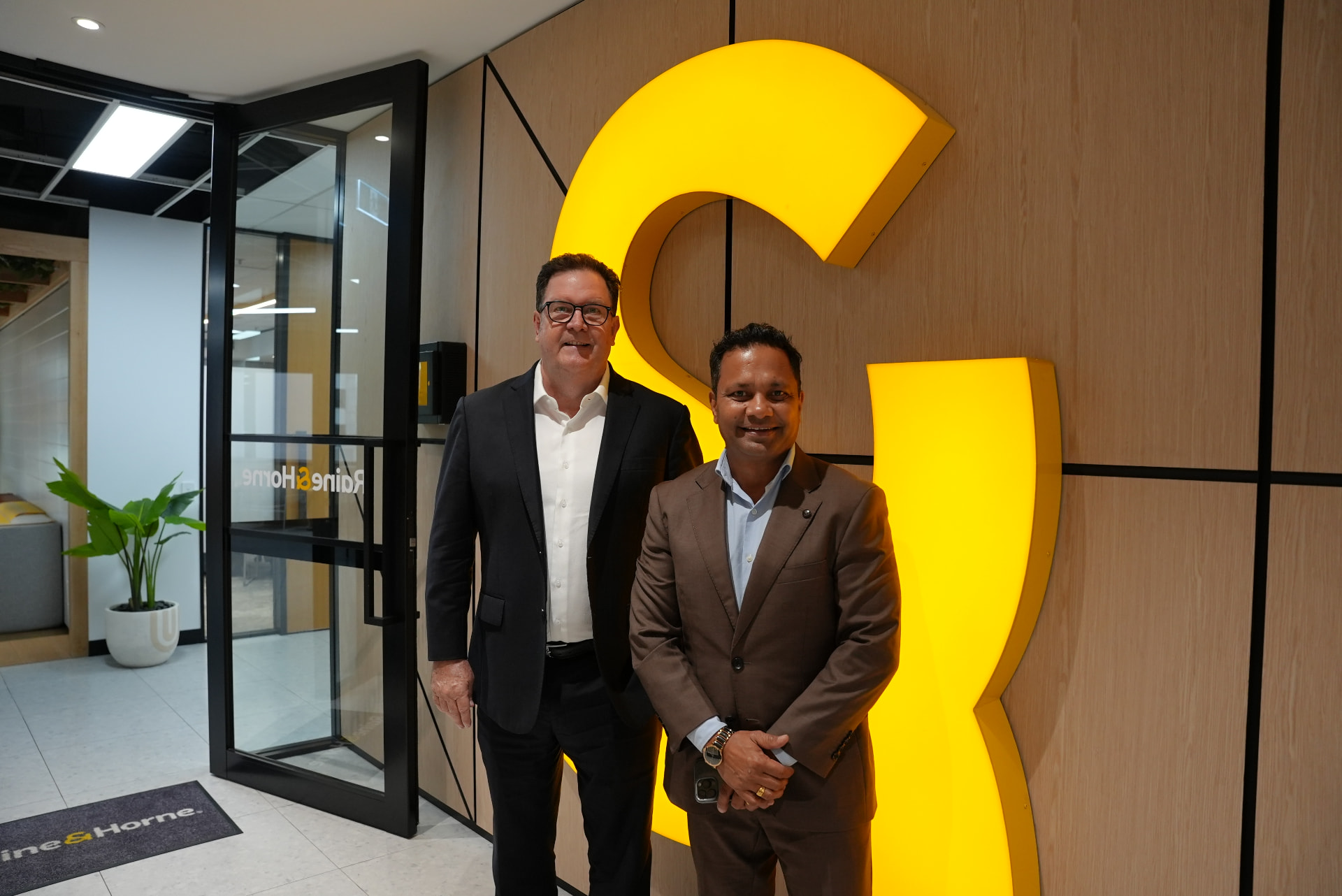 Raine & Horne executive chairman Angus Raine and Raine & Horne North Lakes director Bibek Aryal. Image: supplied